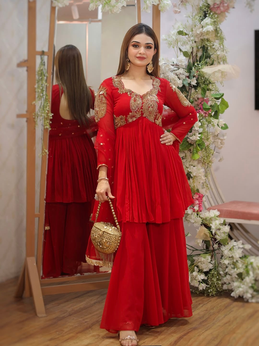 Designer Traditional Red Anarkali Floor-Length Gown with Heavy Golden Zari Embroidery on Bodice and Sleeves, Paired with Golden Beaded Potli Bag and Statement Jewelry – Ideal for Wedding, Festive, or Party Wear