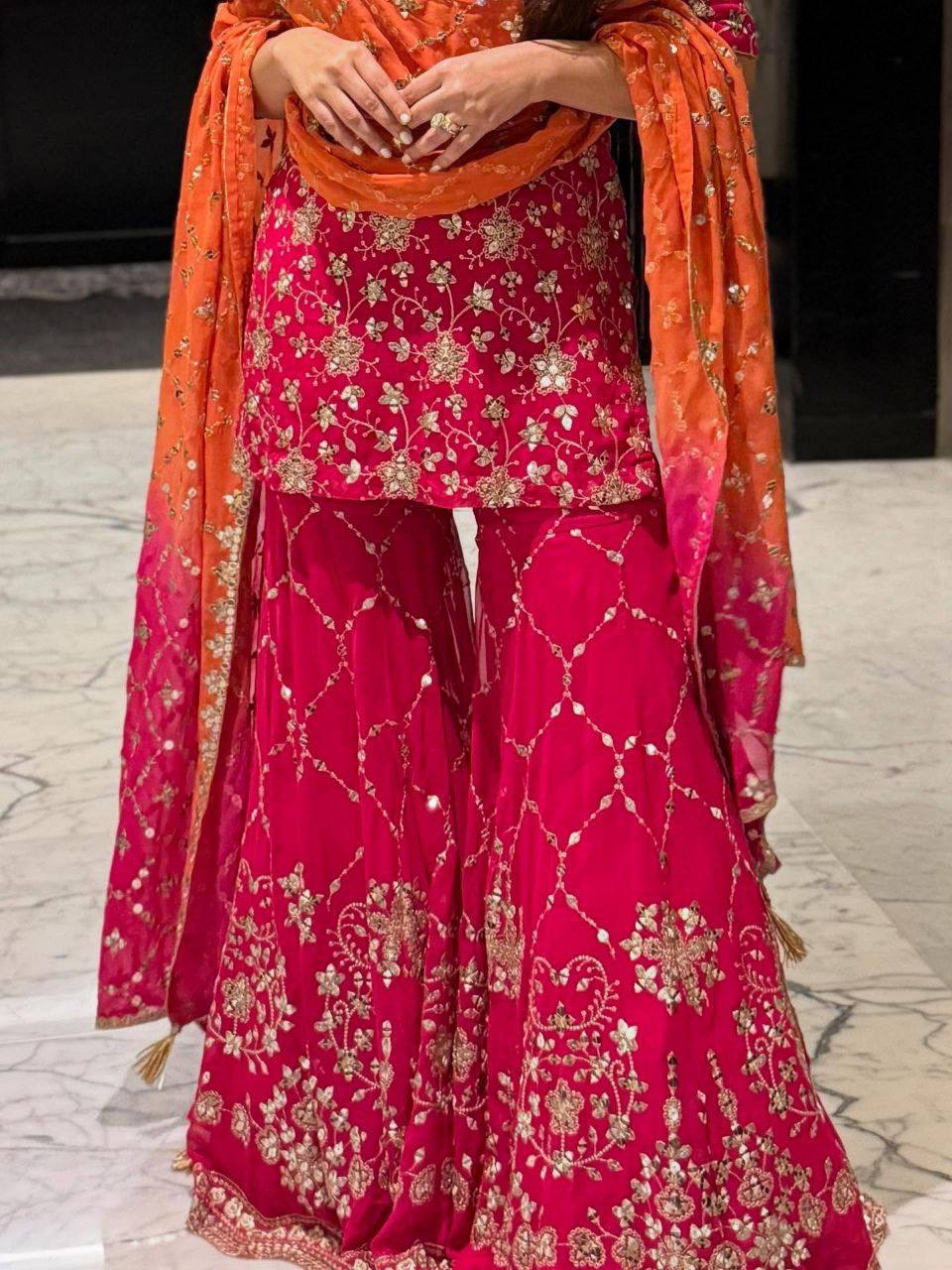 Women’s Designer Pink Sharara Suit Set with Heavy Golden Embroidery, Short Kurta and Flared Sharara Pants with Orange Dupatta – Perfect for Wedding, Party and Festive Wear