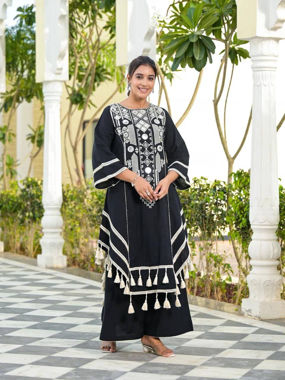 Elegant Black Handcrafted Cotton Kurta Set with Intricate White Mirror Work Embroidery, Asymmetric Hemline, and Tassel Detailing – Bohemian Ethnic Wear for Women – Includes Wide-Leg Pants – Ideal for Festive & Casual Occasions
