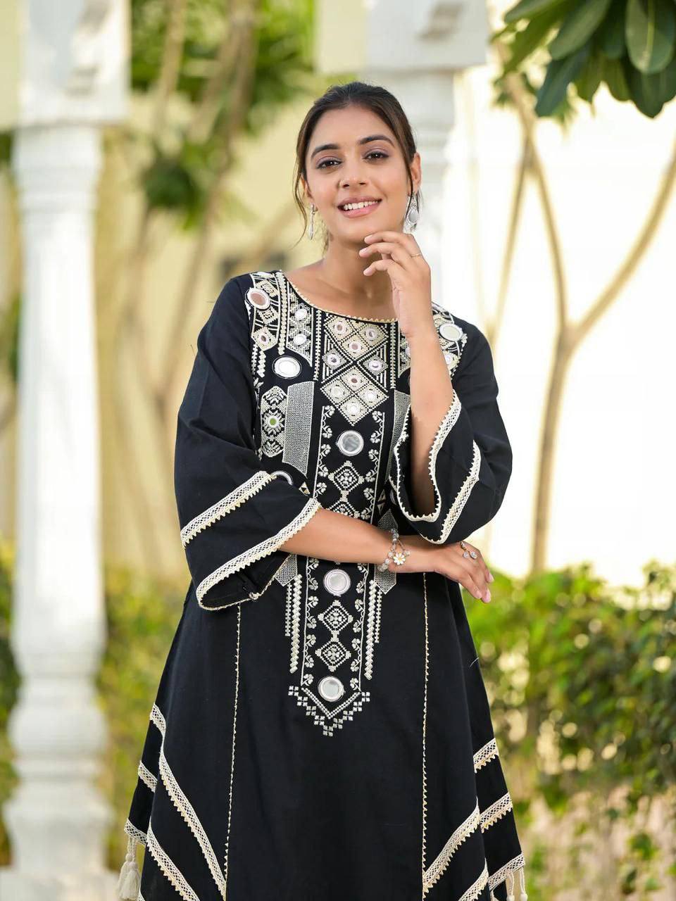 Elegant Black Handcrafted Cotton Kurta Set with Intricate White Mirror Work Embroidery, Asymmetric Hemline, and Tassel Detailing – Bohemian Ethnic Wear for Women – Includes Wide-Leg Pants – Ideal for Festive & Casual Occasions