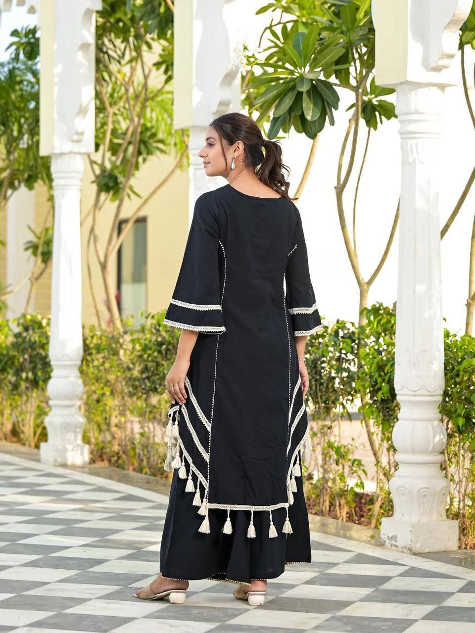 Elegant Black Handcrafted Cotton Kurta Set with Intricate White Mirror Work Embroidery, Asymmetric Hemline, and Tassel Detailing – Bohemian Ethnic Wear for Women – Includes Wide-Leg Pants – Ideal for Festive & Casual Occasions
