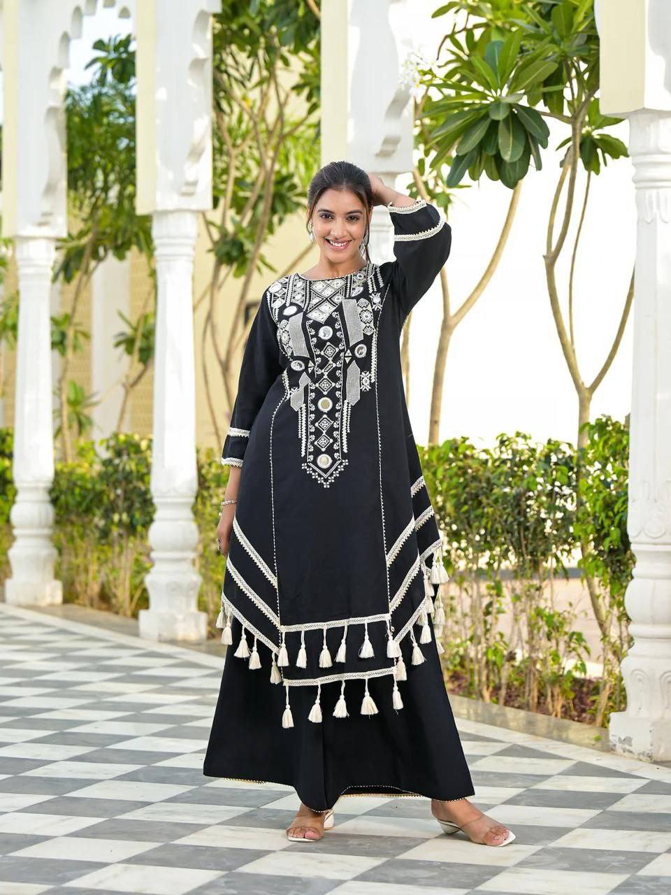 Elegant Black Handcrafted Cotton Kurta Set with Intricate White Mirror Work Embroidery, Asymmetric Hemline, and Tassel Detailing – Bohemian Ethnic Wear for Women – Includes Wide-Leg Pants – Ideal for Festive & Casual Occasions