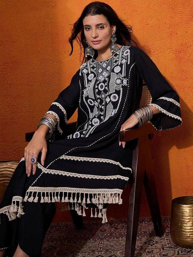 Elegant Black Handcrafted Cotton Kurta Set with Intricate White Mirror Work Embroidery, Asymmetric Hemline, and Tassel Detailing – Bohemian Ethnic Wear for Women – Includes Wide-Leg Pants – Ideal for Festive & Casual Occasions