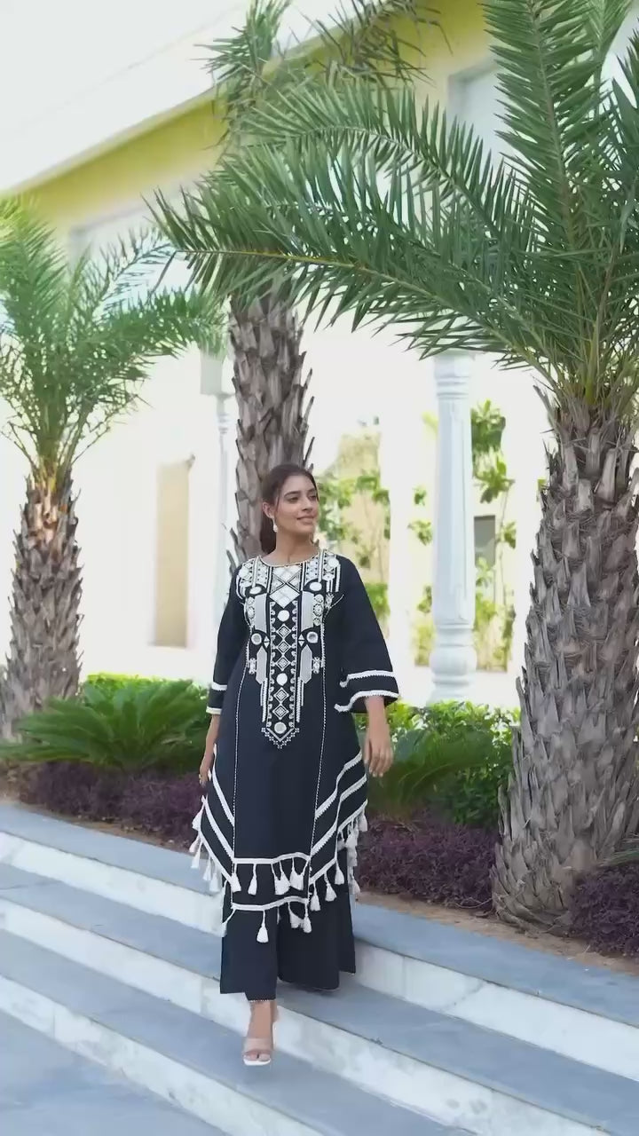 Elegant Black Handcrafted Cotton Kurta Set with Intricate White Mirror Work Embroidery, Asymmetric Hemline, and Tassel Detailing – Bohemian Ethnic Wear for Women – Includes Wide-Leg Pants – Ideal for Festive & Casual Occasions